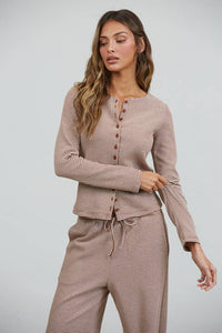 A woman models the Creamon - CTP3592 BROWN Lounge Striped Button Down Top & Pants Set in brown stripe (available in S-M-L), featuring a long-sleeve button-down top and wide leg drawstring pants, against a plain light gray background.