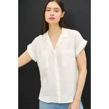 Woman wearing Sibley ivory Tencel button-up blouse with dolman sleeves and high-low hem