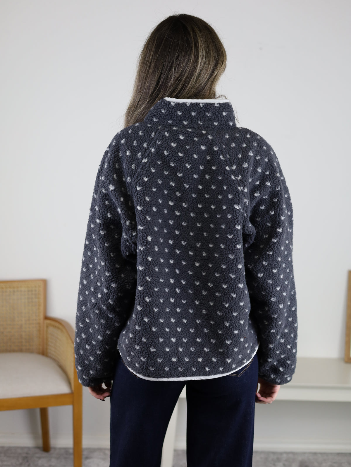 Back view of the Reba Fleece Puffer Jacket in dark gray high-pile fleece with a white heart pattern and a high collar.