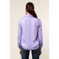 Back view of a person wearing a Naked Zebra - Neck Shirt With Open Seam Sleeve: Wine / L in lavender with open seam sleeves and blue jeans.