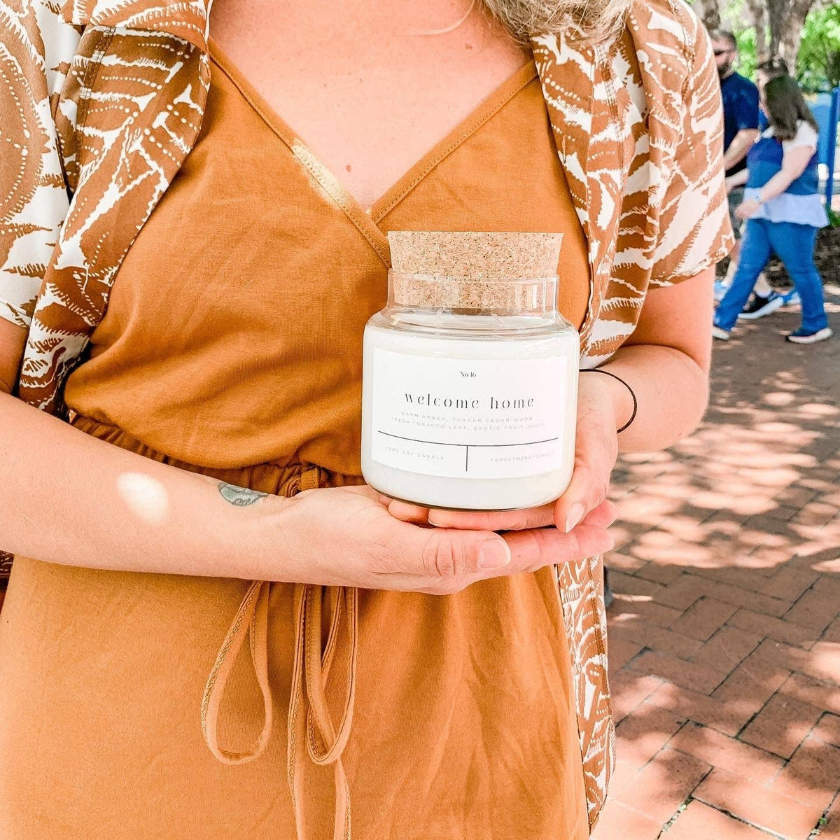 Forget Me Not Welcome Home candle with amber, cedarwood and tobacco leaf scent notes