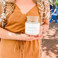 Forget Me Not Welcome Home candle with amber, cedarwood and tobacco leaf scent notes