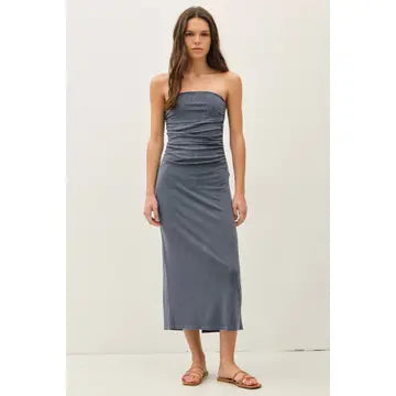 Woman wearing Maggie blue ribbed strapless tube midi dress with a back slit