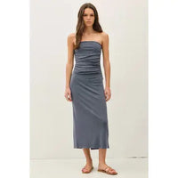 Woman wearing Maggie blue ribbed strapless tube midi dress with a back slit