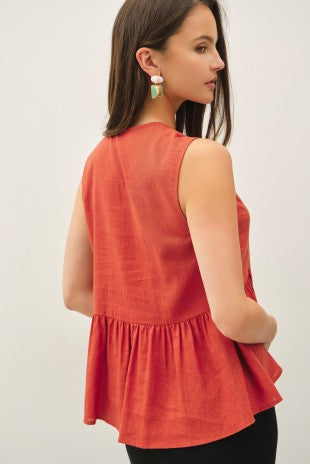 Patricia peplum top in terracotta styled, back view