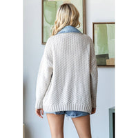A woman with blonde hair, seen from behind, wears the Veveret - Knit Body Denim Layerd Jacket: Cream / Denim / L and denim shorts, standing indoors before two abstract paintings.