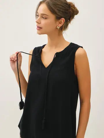 Black linen blend V-notch swing blouse with tassel ties from Glitz Fine Clothing
