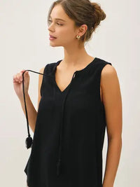 Black linen blend V-notch swing blouse with tassel ties from Glitz Fine Clothing