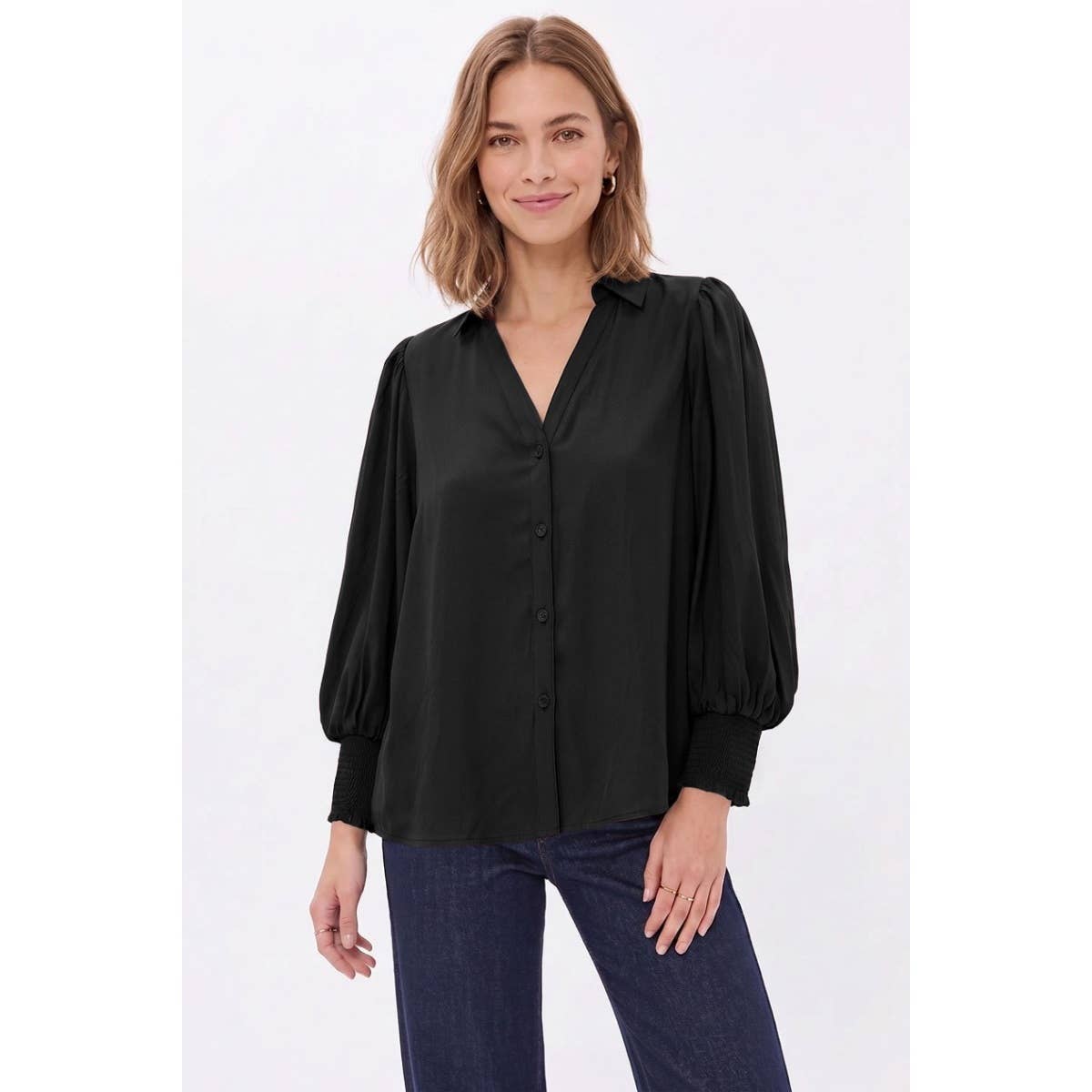 A person wears a Naked Zebra - Soft Billowy Sleeve Button Front Blouse: Wine / L, featuring a V-neck and billowy sleeves with smocked cuffs.