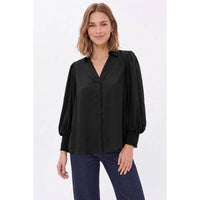 A person wears a Naked Zebra - Soft Billowy Sleeve Button Front Blouse: Wine / L, featuring a V-neck and billowy sleeves with smocked cuffs.