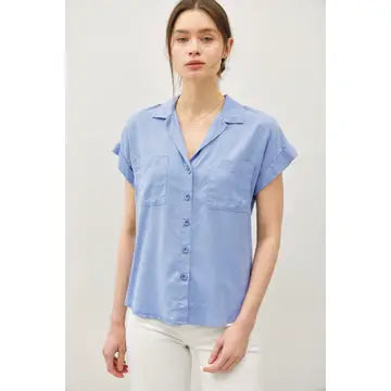 Woman wearing Sibley blueberry Tencel button-up blouse with dolman sleeves and high-low hem