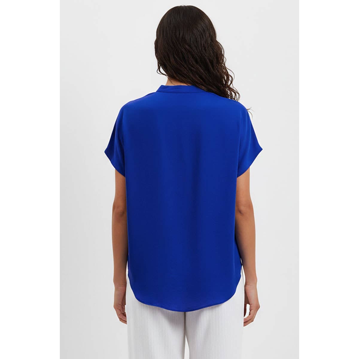 Back view of a person wearing a bright blue, short-sleeved, drop-shoulder Naked Zebra - Drop Shoulder Regular Blouse: Chocolate / L with a curved hem.