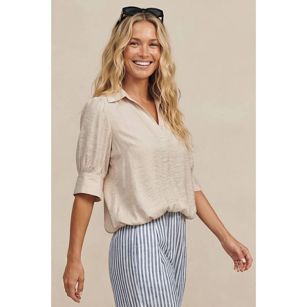 A woman smiling while wearing a wine Naked Zebra - Half Sleeve Hi-lo Bubble Hem Blouse: Wine / L, featuring a beige, half-sleeve bubble hem with a v-neck collar.