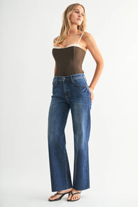Close-up of raw scissor cut hem on Ingrid High Rise Slim Palazzo Jean