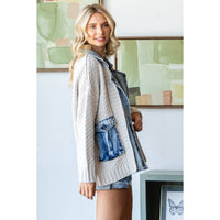 A woman with long blonde hair smiles indoors near abstract green art, wearing the Veveret - Knit Body Denim Layerd Jacket: Cream / Denim / L and denim shorts.
