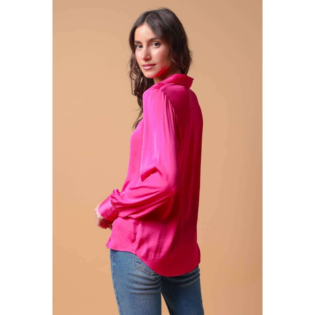 A person wearing a fuchsia, woven polyester Naked Zebra - Neck Shirt With Open Seam Sleeve: Wine / L with open-seam sleeves and blue jeans.
