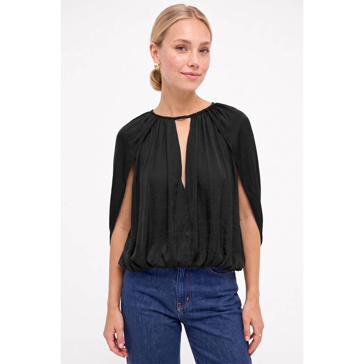 A woman wearing a Naked Zebra - Silky Draped Cape Sleeve Blouse: Wine / L, featuring long cape-style sleeves and a front keyhole cutout.