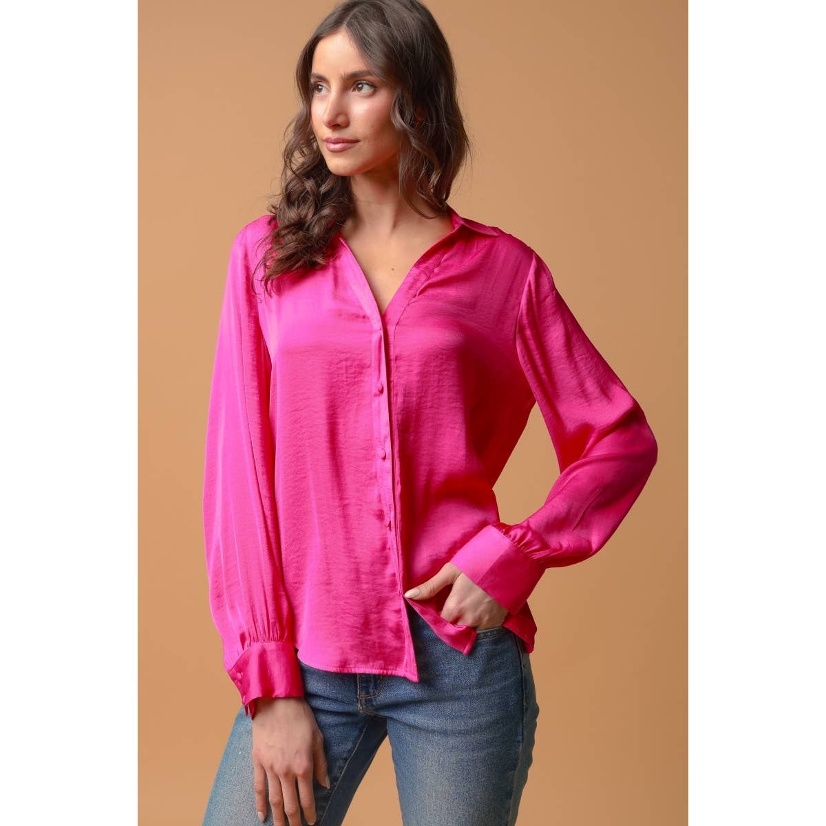 A person wears a bright pink Naked Zebra - Neck Shirt With Open Seam Sleeve: Black / L, featuring long sleeves with open seam detail, paired with blue jeans.