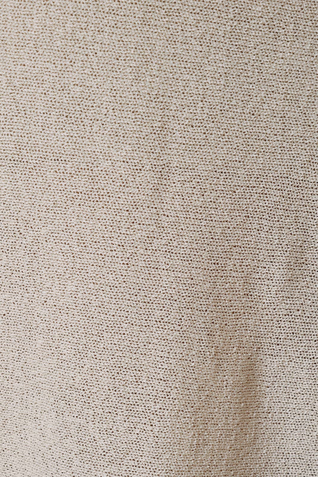 Close-up of a brown, textured fabric with a fine, open-knit pattern from the Sunday Edition by LE LIS - LOOSE FIT OPEN KNIT SWEATER CAPE TOP (Size: Large). The material appears soft and slightly uneven, featuring subtle variations in shading and thread placement—ideal for highlighting model specs or complementing women’s measurements.