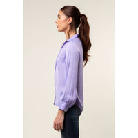 Side profile of a person wearing a light purple Naked Zebra - Neck Shirt With Open Seam Sleeve: Wine / L with open-seam sleeves and blue jeans.