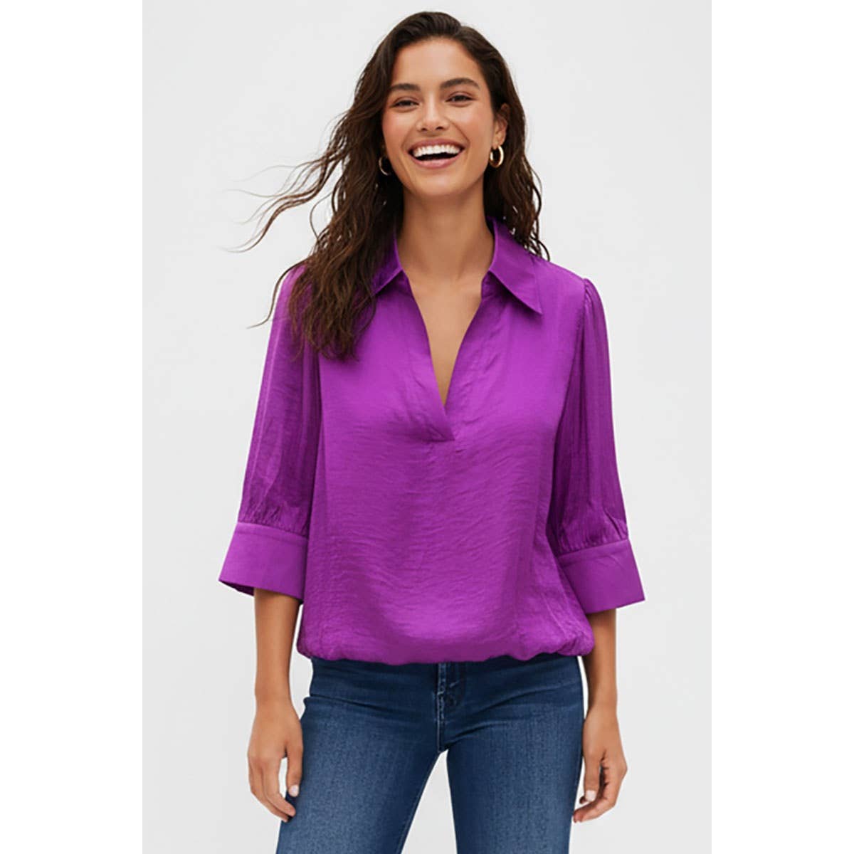 A woman wearing a Naked Zebra - Half Sleeve Hi-lo Bubble Hem Blouse: Wine / L, featuring a collared V-neck and blue jeans.