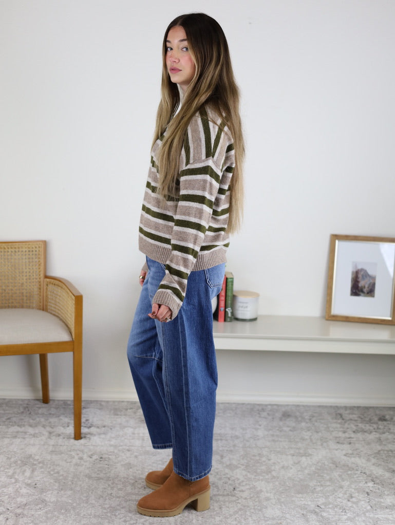 A person wearing a cozy mocha wool-blend Alexandria Striped Classic Sweater, blue jeans, and tan ankle boots.