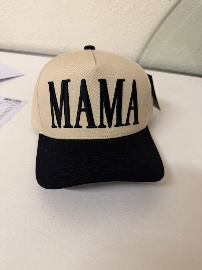 Introducing our Baseball Cap - MAMA, a chic beige and black cap featuring the word “Mama” in bold black letters across the front. Displayed on a white surface, this cap is perfect for any mom looking to add a stylish accent to her everyday wardrobe.