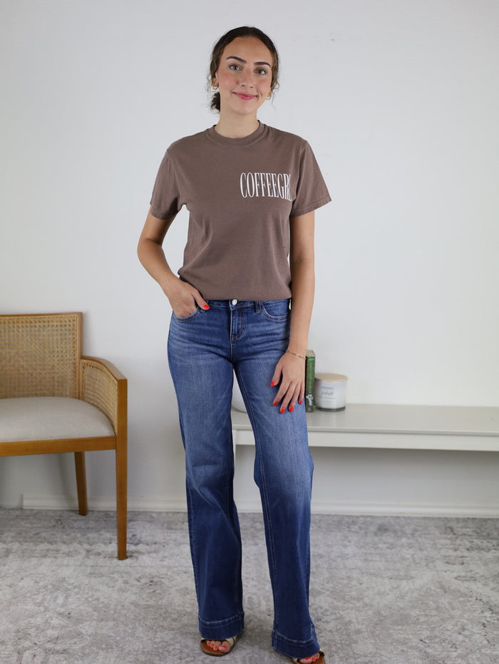 Woman wearing the Coffeegrl Coffee Tee, a brown espresso graphic tee for coffee lovers, paired with blue jeans