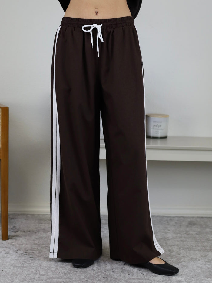 Urban Wide Leg Side Stripe Linen Track Pant in dark brown with white side stripes, a white drawstring waistband, and a sporty wide-leg lounge design.