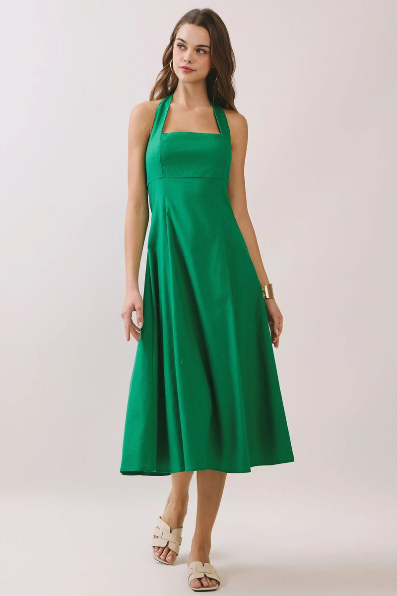 Woman wearing Blyth green halter smocked midi dress with a self-tie back