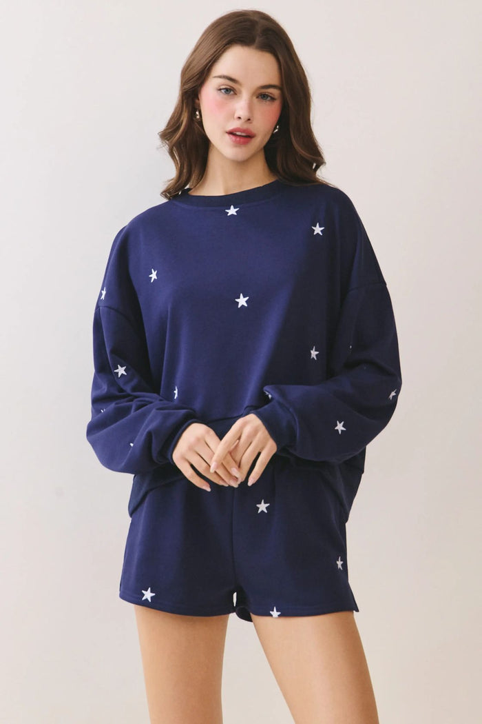 Woman wearing Lulu navy allover star embroidery drop-shoulder sweatshirt