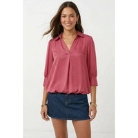 A woman wearing a wine Naked Zebra - Half Sleeve Hi-lo Bubble Hem Blouse with a collared V-neck, paired with a dark denim miniskirt.