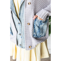 A person wears the Veveret - Knit Body Denim Layerd Jacket: Cream / Denim / L, featuring a relaxed fit, textured knit, large wooden buttons, and a denim pocket with one hand inside.