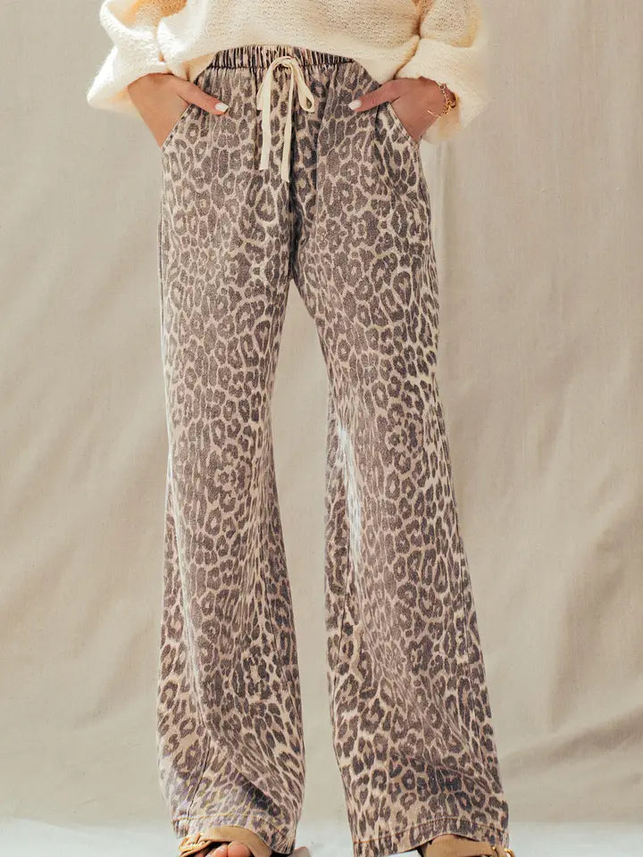 Woman wearing rust leopard print wide-leg cotton pants with a cream sweater, front view