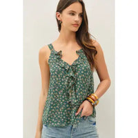 Woman wearing Paige green floral ruffle tank with a ruffled V-neck and chiffon drape