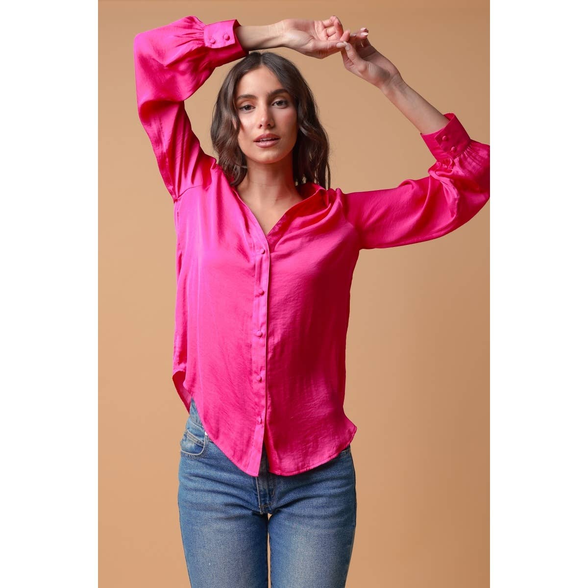 A person wears a Naked Zebra - Neck Shirt With Open Seam Sleeve: Wine / L, a long-sleeved, fuchsia woven polyester button-down shirt with open-seam sleeves, paired with blue jeans.