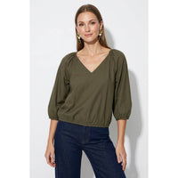 Burgundy Naked Zebra - Elastic Puff Sleeve V-neck Blouse with three-quarter length puff sleeves and an elasticated hem worn with dark blue jeans.