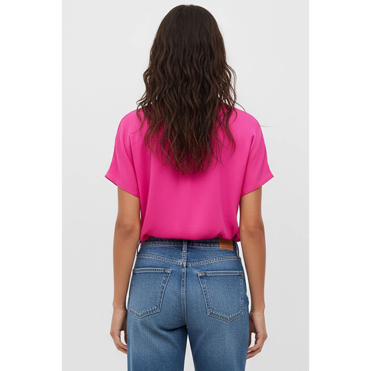 Back view of a person wearing a bright pink woven polyester Naked Zebra - Drop Shoulder Regular Blouse: Chocolate / L tucked into blue jeans.