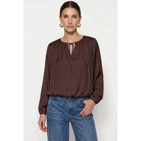 Naked Zebra - Long Sleeve Draped Bubble Hem Blouse: Wine / L, a long-sleeve, dark wine-colored satin blouse with a gathered neckline and tie detail, worn with blue jeans.