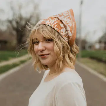 Woman wearing the Terra bandana tied as a neck scarf