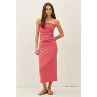 Woman wearing Maggie red ribbed strapless tube midi dress with a back slit